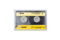 Yellow BASF audio cassette, retro audio technology, on white background