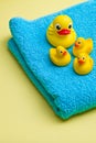 Yellow bath duck on blue towel