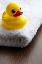 Yellow bath duck on white towel Royalty Free Stock Photo