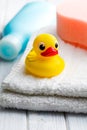 Yellow bath duck on white towel