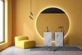 Yellow bathroom interior, marble sink and armchair Royalty Free Stock Photo