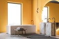 Yellow bathroom with tub and sinks Royalty Free Stock Photo