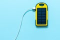 Yellow Battery solar power device on a blue background.