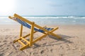 An yellow beach chair rests on the white sand Royalty Free Stock Photo
