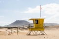 Yellow beach safety flag warning. Lifeguard tower. Royalty Free Stock Photo