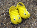 Yellow beach slippers in the form of caterpillars Royalty Free Stock Photo