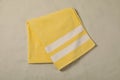 Yellow beach towel on sand, top view Royalty Free Stock Photo