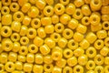 Yellow beads for needlework, used to make bracelets, beads and other jewelry