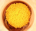 Yellow beads in wooden bowl. Jewelry. Creativeness