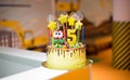 yellow beautiful delicious chocolate cake with gingerbread decorations. Edible stars and candy on the cake. 5 candles. cake