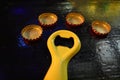 Beer opener and capsules on a table