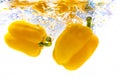 Yellow bell pepper with water splash isolated on white. Royalty Free Stock Photo