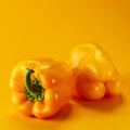 Yellow bell peppers on a yellow background