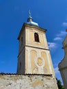 Yellow bell tower with old facade with blue sky in the background Royalty Free Stock Photo