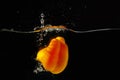 Yellow bellpepper falling into water with splash Royalty Free Stock Photo