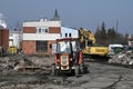 Yellow Komatsu excavator and old small Ursus tractor after its work at a construction site