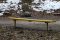 Yellow bench in the park in winter Royalty Free Stock Photo