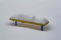 Yellow bench under a large snowdrift Royalty Free Stock Photo
