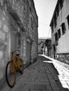 Yellow bicycle in a black and white street in Stari Grad in Hvar island Croatia Royalty Free Stock Photo