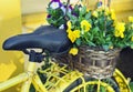 Yellow bicycle decorated with flowers