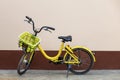 A yellow bicycle parked next to the house Leave space for the text