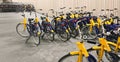 Yellow bicycle rental station on city street