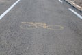 Yellow bicycle sign on asphalt Royalty Free Stock Photo
