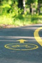 Yellow bicycle sign on the bike lane in the park Royalty Free Stock Photo