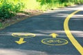 Yellow bicycle sign on the bike lane in the park Royalty Free Stock Photo