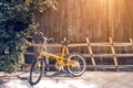 Yellow bicycle on vintage wooden house wall Royalty Free Stock Photo