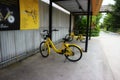 Yellow bicycles in public parking lots for exercise