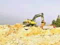 Yellow big excavator in the coal mine, loads the breed Royalty Free Stock Photo