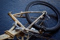 Yellow bike chained to a post with a stolen wheel. bike without a stolen seat Royalty Free Stock Photo