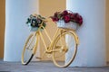 Yellow bike with flower baskets