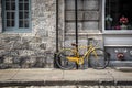 Yellow bike next to historic stone building in Montreal Royalty Free Stock Photo