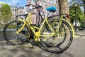 Yellow bike parked in the streets of amterdam
