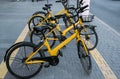 The yellow bikes for hire on the parking