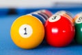 Yellow billiard ball number one and other colorful balls placed Royalty Free Stock Photo