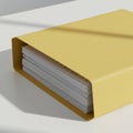 A yellow binder containing a stack of white papers is placed on a smooth, light- Royalty Free Stock Photo