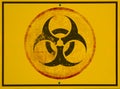 Yellow biohazard danger sign closeup with black border.