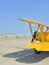 Yellow biplane at airfield Royalty Free Stock Photo