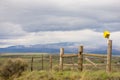 Yellow Birdhouse On A Fence In Colorado With Black Mountain In Background