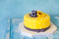 Yellow birthday cake with anemones