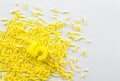 Yellow birthday number 5 candle on top of bright yellow birthday sprinkles over white background with space for text