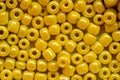 Yellow beads for needlework, used to make bracelets, beads and other jewelry