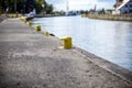 Yellow bitt on port channel quayside mooring Royalty Free Stock Photo