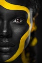 Yellow and black body paint. Woman with face art. Young girl with colorful bodypaint. An amazing afro american model