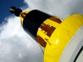 Yellow and black buoy against clear summer sky Royalty Free Stock Photo