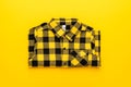 Yellow and black checkered shirt on the yellow background. centre composition