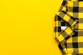 Yellow and black checkered shirt on the yellow background with copy space